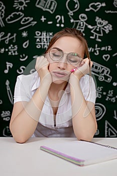 Young female student sleeping in a classroom