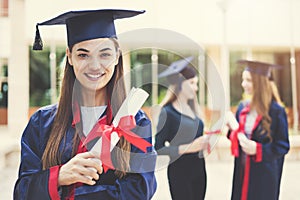 Young female students graduating from university