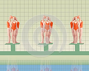 Young female swimming athletes in red swimsuits standing on starting blocks, ready to jump into pool and swim