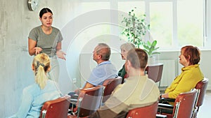 Young female teacher conducts training for the elderly at the university