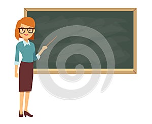 Young female teacher on lesson at blackboard in classroom