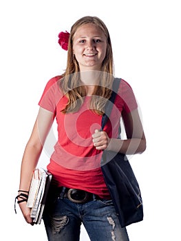 Young female teenage student carrying books