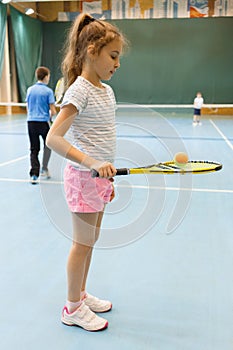 Young female tennis player on tennis court holding
