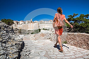 Young female tourist admiring the Old Town of Bonifacio