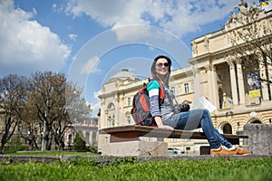 Young female tourist with map and camera