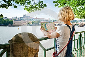 Young female tourist studying a map of Prague.