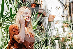 young female tourist talking by phone in a mediterranean village during summer holidays