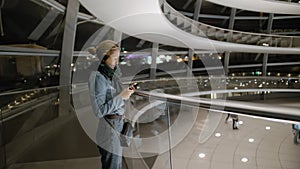 Young female tourist uses an audio guide. Inside the Bundestag, in Berlin. Slow Motion