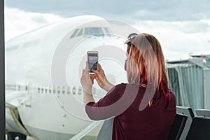 young female traveler, Blogger in airport lounge near windows happy smile taking selfie photo flight