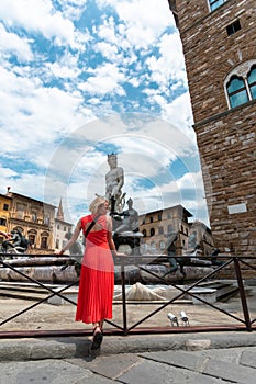 Young female traveler near famous Neptun fountain in Florence.