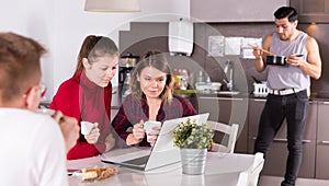 Female travelers planning itinerary in hostel kitchen photo