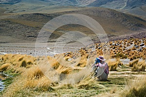 Young female traveller is using binoculars to see remoted objects