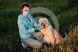 Young female using a face mask as a coronavirus spreading prevention and blue medical gloves to protect