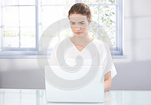 Young female using laptop at home