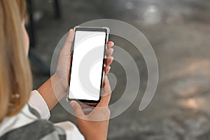 Young female using mobile phone with montage screen display