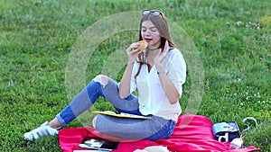 Young Female using tablet eating french fries junk food