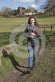 Young female vicar walking in her parish