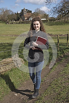 Young female vicar walking in her parish