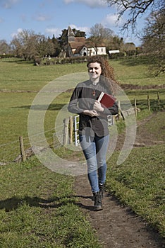 Young female vicar walking in her parish