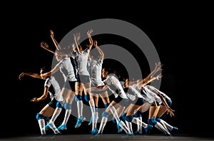 Young female volleyball player isolated on black studio background