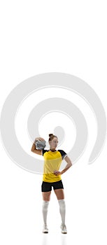 Young female volleyball player isolated on white studio background. Woman in sport's equipment training and practicing.