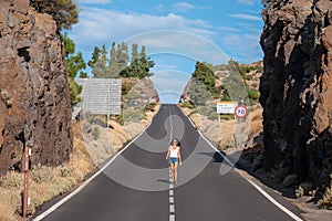 Young Female walking on the road in Teide volcano crater