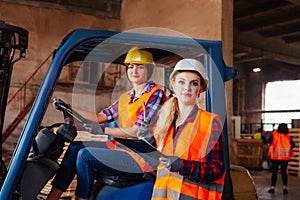 Young female warehouse workers solving working issues
