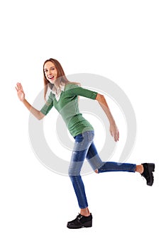 Young female youth rushing forwards and waving one hand in studio