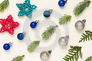 Young fir twigs and baubles on white background.