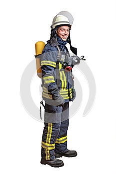 Young fireman with a mask and an air breathing apparatus on his back in a fully protective suit