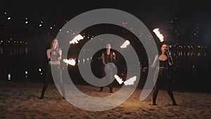 Young fireshow artists juggling fire poi outdoor