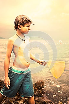 Young fisherman looks the horizon at sea