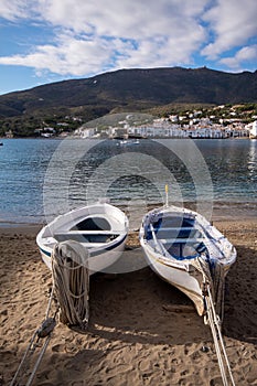 Young fishermen's boats parked on the sand of one of the beaches in the town of Cadaques looking out