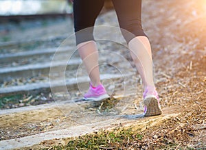 Young Fit Adult Woman Outdoors Walking or Running Up Wooden Step