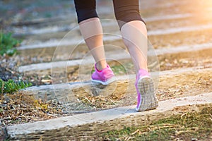 Young Fit Adult Woman Outdoors Walking or Running Up Wooden Step