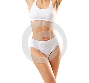 Young, fit and beautiful woman in white swimsuit over white background. The concept of healthcare, diet, sport and