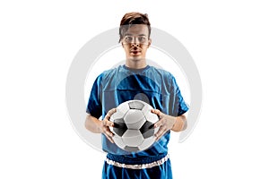 Young fit boy with soccer ball standing isolated on white