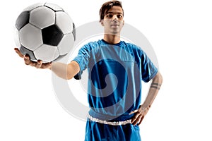 Young fit boy with soccer ball standing on white