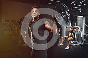 Young and fit couple in the gym doing workout