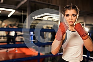 Young fit female training, boxing in ring