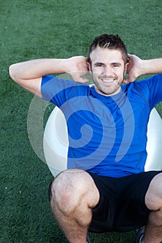 Young fit male athlete on workout ball