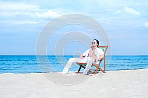 Young and fit man chilling on the beach