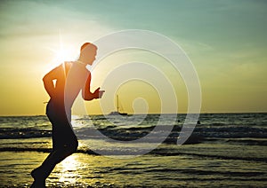 Young, fit man doing jogging on a tropical beach