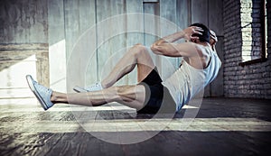 Young fit man exercising in a gym