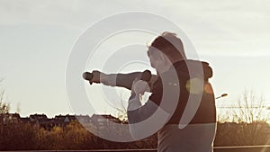 Young and fit man having evening workout outdoor. Urban sunset background. Fitness and sport.