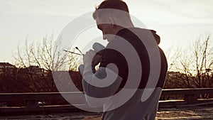 Young and fit man having evening workout outdoor. Urban sunset background. Fitness and sport.