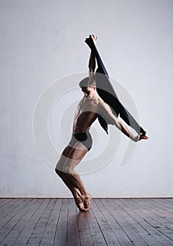 Young and fit modern dancer performing a move