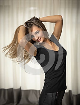 Young, fit and slim, beautiful woman with an expression on her face - joy, desire, reverie, pensiveness, thoughts. Romantic pose.