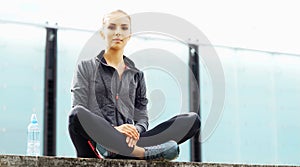 Young, fit and sporty brunette girl in sportswear. Woman doing sports outdoor.