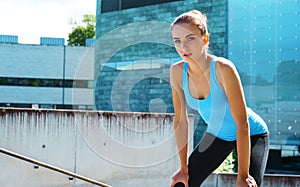 Young, fit and sporty brunette girl in sportswear. Woman doing sports outdoor.